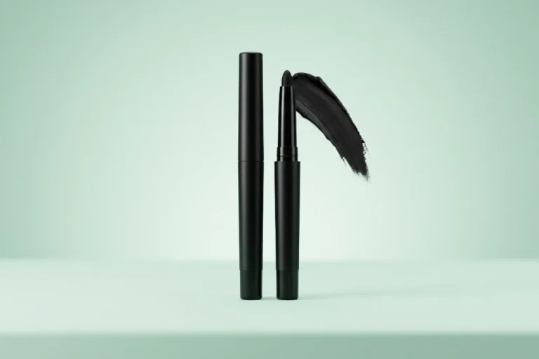 Premium smudge-proof deep black kajal pencils and cosmetic gel swipes on a minimal mint green background for a beautybeauty.in Malayalam review guide.