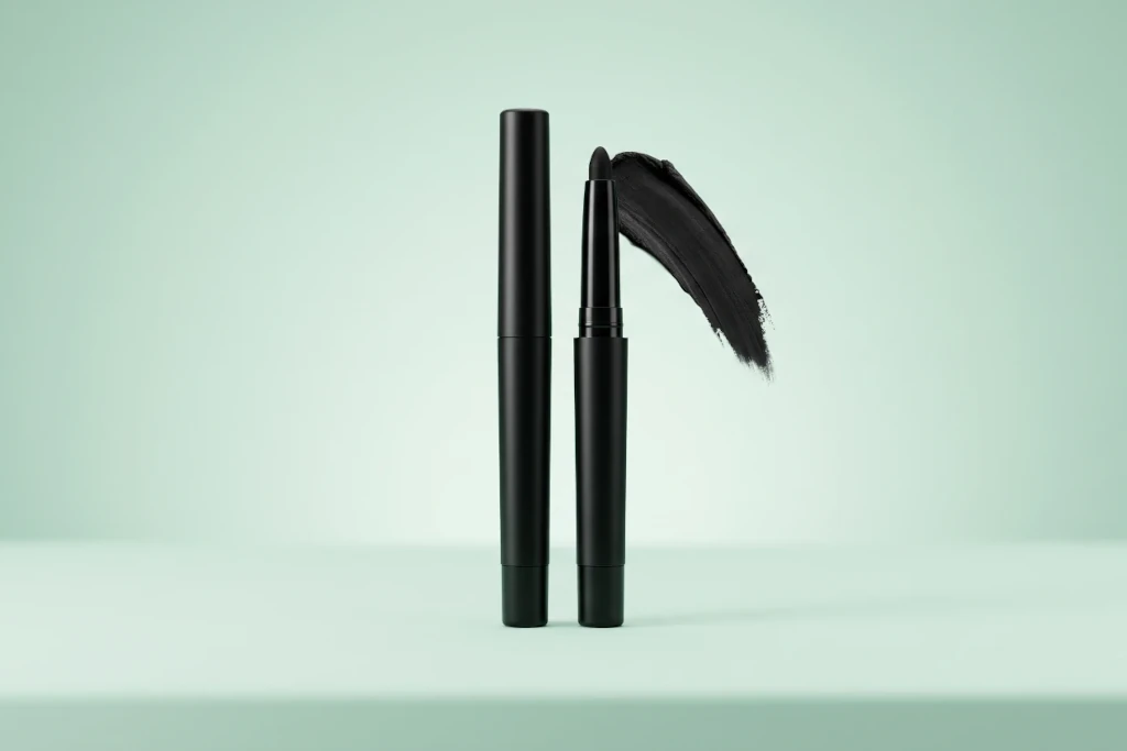Premium smudge-proof deep black kajal pencils and cosmetic gel swipes on a minimal mint green background for a beautybeauty.in Malayalam review guide.